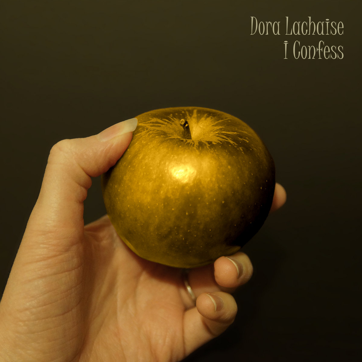 Cover art for I Confess: a hand holding a golden apple.