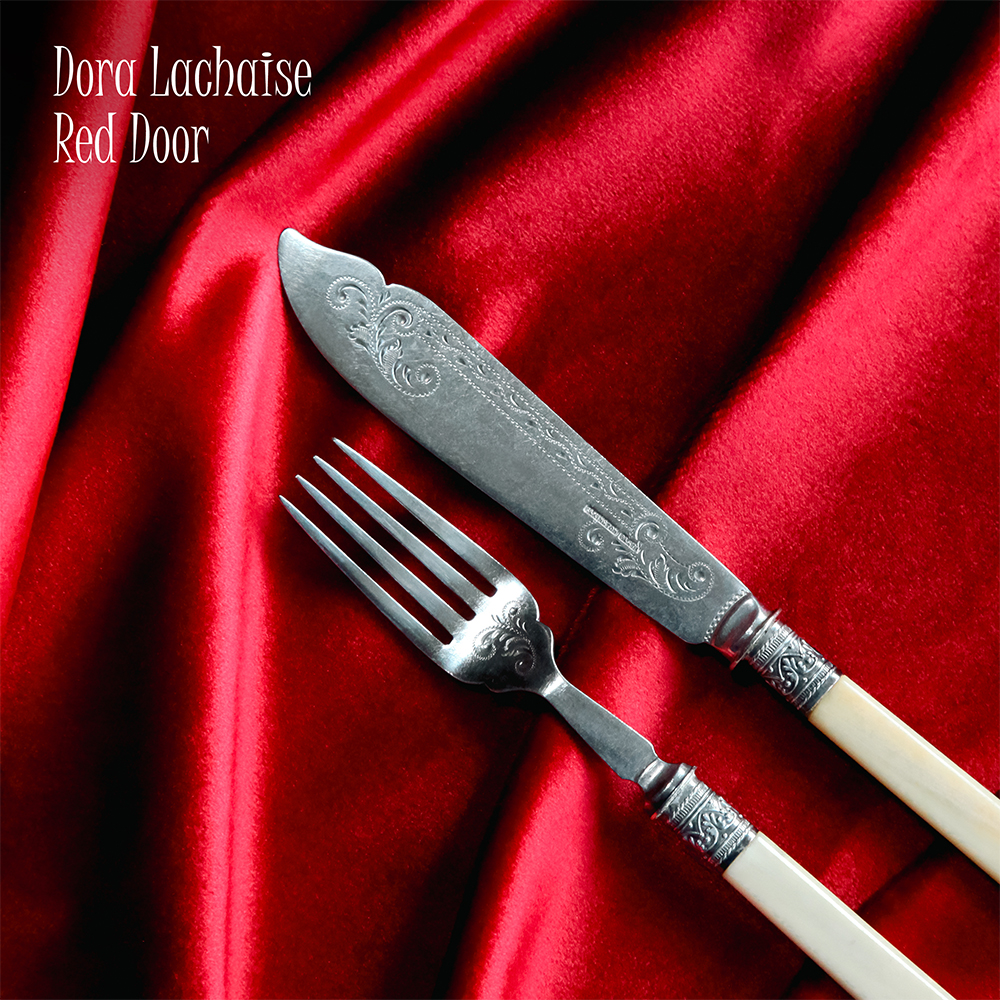 Cover art for Red Door: an antique knife and folk on a soft red cloth